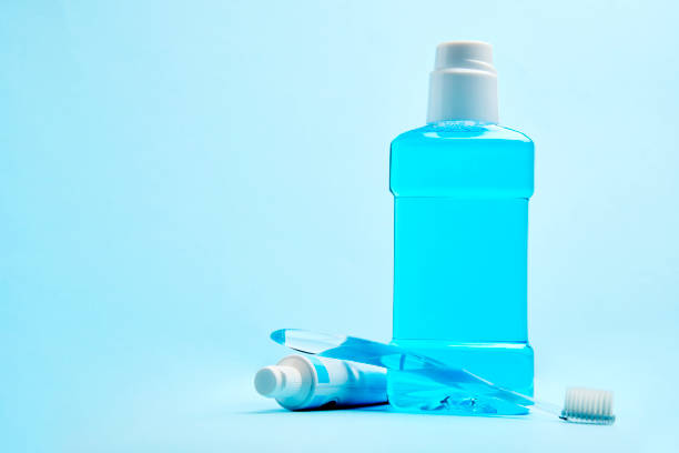 istock A toothbrush with toothpaste and mouthwash on blue background 1452407348