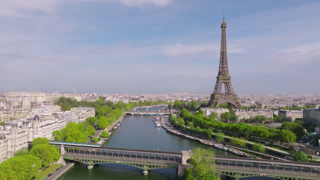 Drone view of the most popular attraction in the world in Paris. Drone flying near the eiffel tower in summer. The bridge of the old metro in the foreground