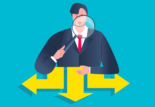 Deciding with the choice of direction, the best decision and the right direction, the businessman takes a magnifying glass to check and examine the arrows in three different directions