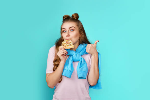 istock young pretty woman eating delicious pizza slice 1452410875
