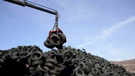 istock Crane hook picking up stacked tires at the landfill 1452413346