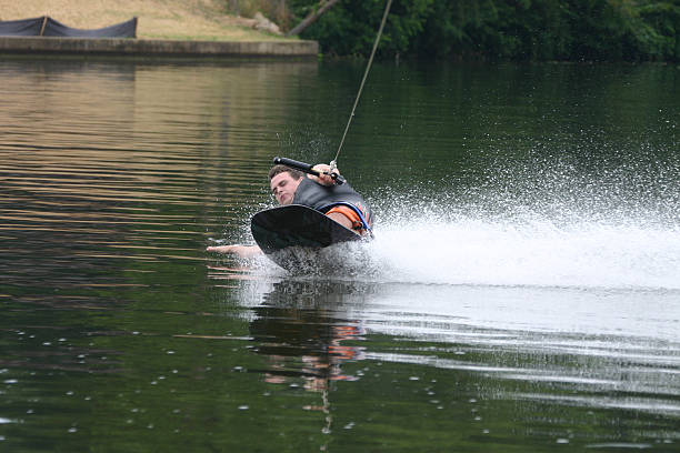 Kneeboarder leaning stock photo