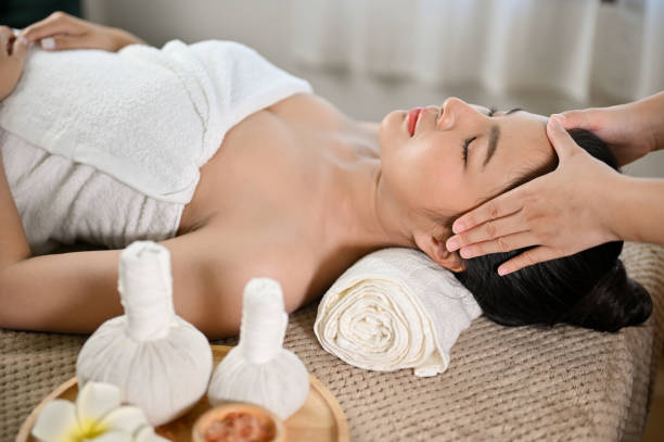 istock side view, Beautiful and relaxed Asian woman receiving Thai massage, getting massage on her head 1452420573