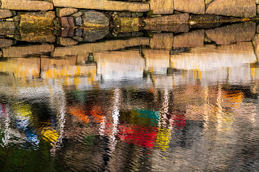 Boat reflection in water at Rockport Harbor, Maine, USA