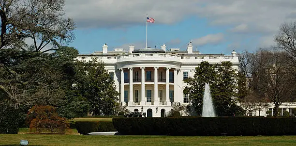 The front of the US President's house and lawn, with the Flag very visible on top.