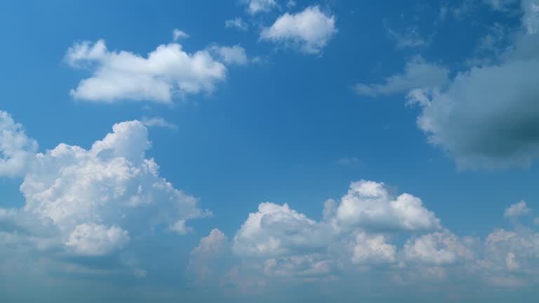 White big fluffy cumulonimbus clouds and blue sky. Cumulus background sky white bomb explosion. Timelapse.