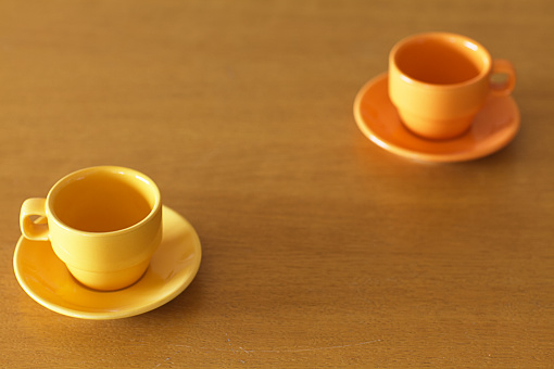 Two empty espresso cups on a wooden table