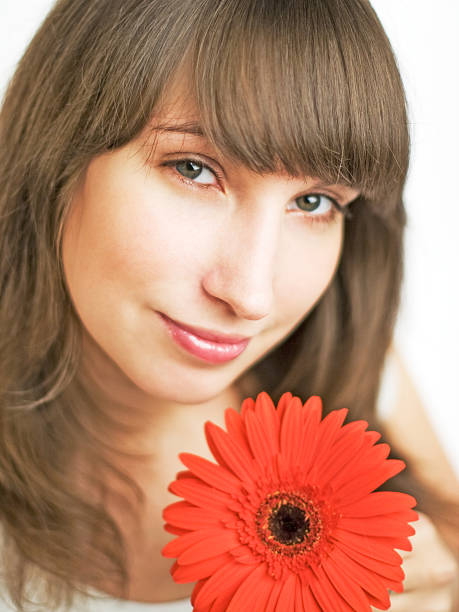 Beautiful girl holding red flower