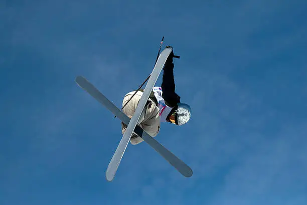 Male freestyle skier flying in the air.