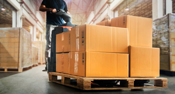 istock Workers Unloading Packaging Boxes on Pallet in Warehouse. Cartons, Cardboard Boxes. Supplies Shipping Warehouse. Supply Chain Shipment Goods. Warehouse Logistics. 1452432304