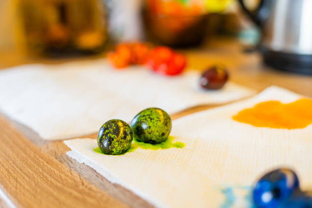Freshly painted colorful easter quail eggs lie in the kitchen