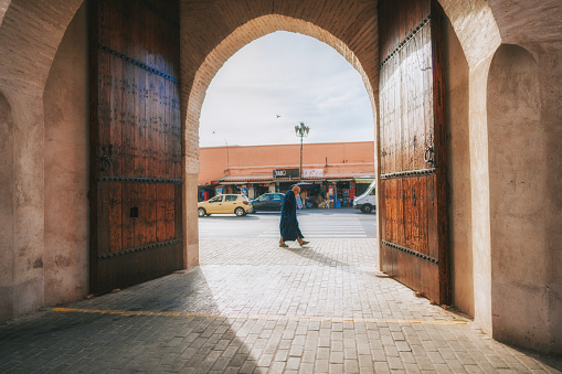 Moroccan elder man with religious clothing walking in sidewalk of Marrakech , Morocco on November 15th year 2022