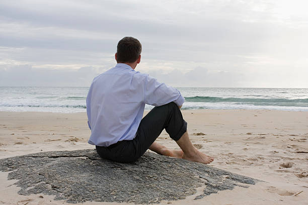 istock A businessman sitting on a bench 145243374