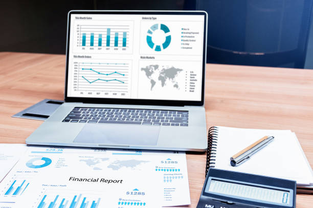 istock Slide show presentation on display laptop with calculator and paperwork on table in meeting 1452435494