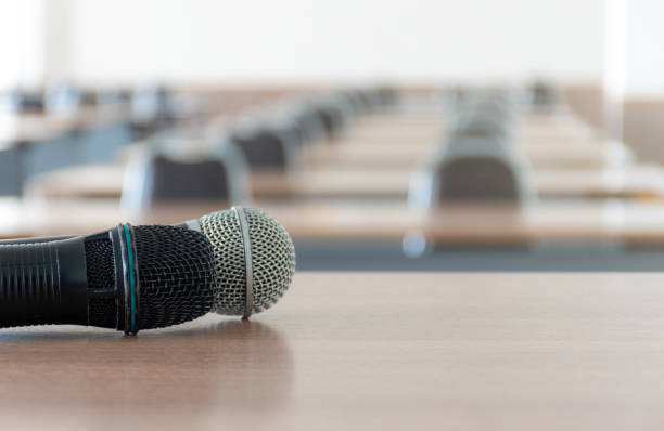 istock Close up microphone on the speaker table in seminar room 1452436240