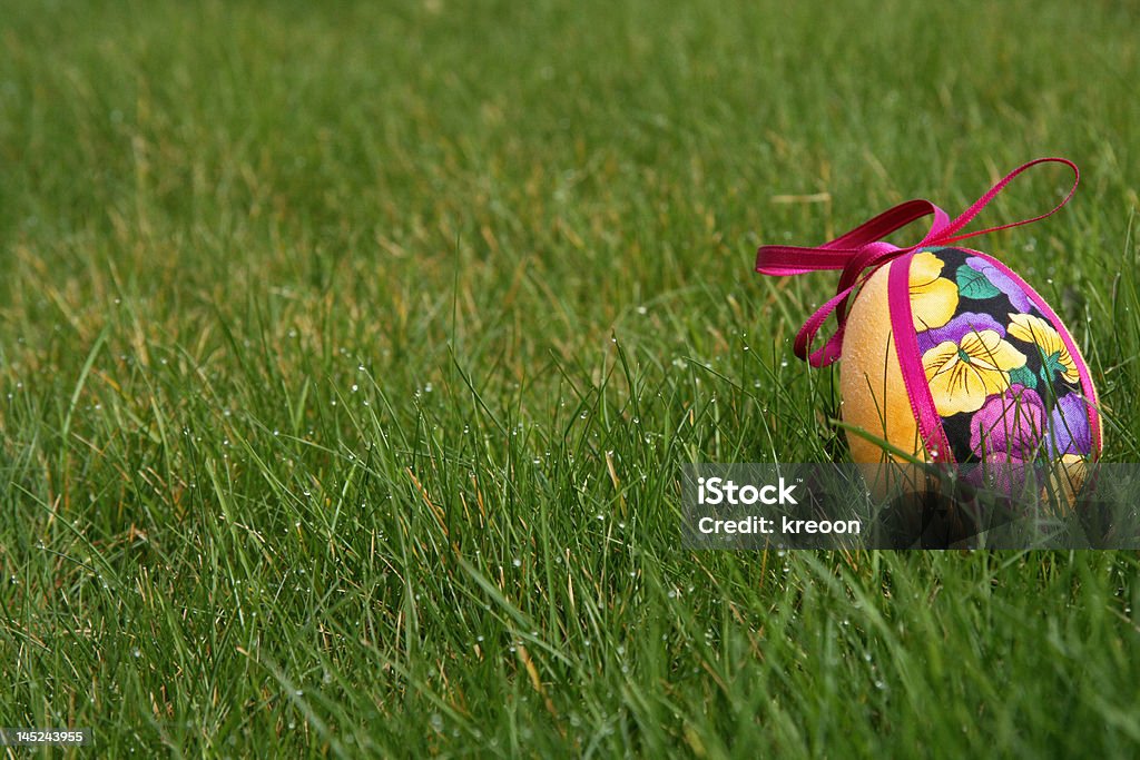 Easter eggs in meadow hand crafted colorful easter eggs in a green meadow April Stock Photo