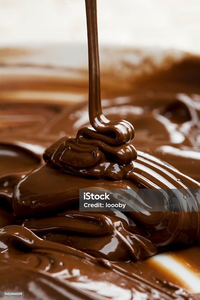 Milk chocolate being poured into bowl lots of chocolate falling from above Chocolate Stock Photo