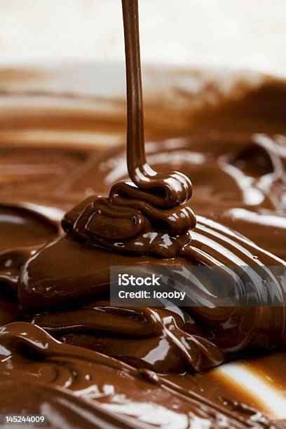 Milk Chocolate Being Poured Into Bowl Stock Photo - Download Image Now - Chocolate, Fudge Sauce, Melting