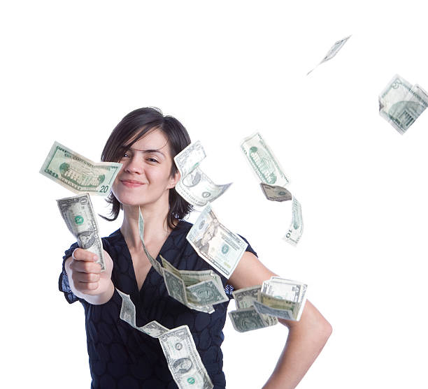 istock A woman showered in money while holding a dollar  145244054