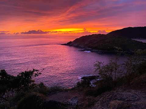Romantic colors sunset over calm sea in Phuket. Magic twilight by ocean in Thailand