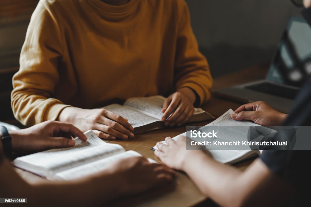 Christian couple or group reading study the bible together and pray at a home or Sunday school at church. concept studying the word of god. Bible Stock Photo