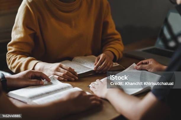 Christian Couple Or Group Reading Study The Bible Together And Pray At A Home Or Sunday School At Church Concept Studying The Word Of God Stock Photo - Download Image Now