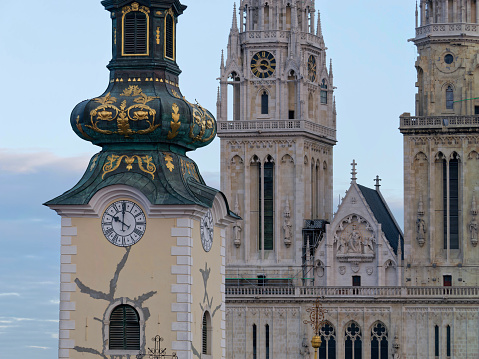 Close-up photo of a tower of the Church of St. Mary and Zagreb Cathedral in the background Zagreb, Croatia