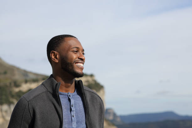 Happy black man contemplating in nature
