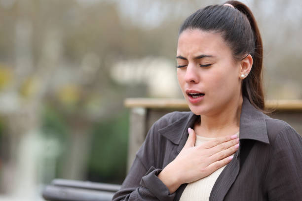 istock Woman with breathing problems in a park 1452444953