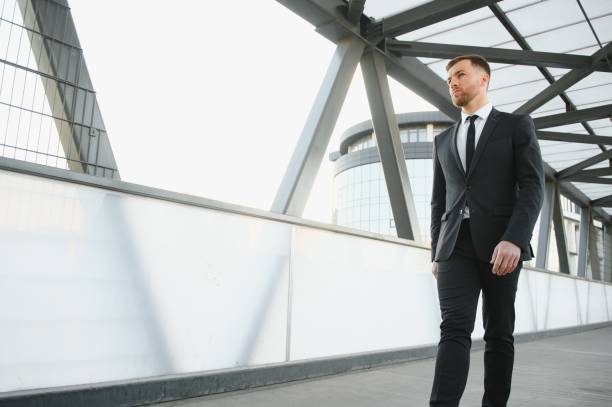 istock Handsome male model posing wearing a back suit. 1452445118