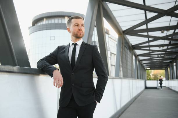 istock Handsome male model posing wearing a back suit. 1452445707
