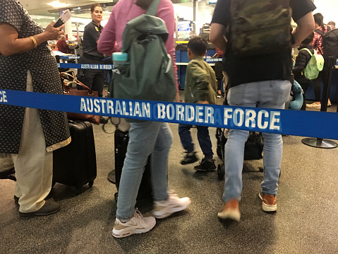 Brisbane - Dec 02 2022:Passengers walking through Australian border force lines. The federal law enforcement agency responsible for border control enforcement, compliance and detention in Australia.
