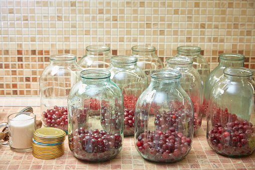 Preparation in three-liter jars of cherry compote. Manufacturing process. Lifestyle.