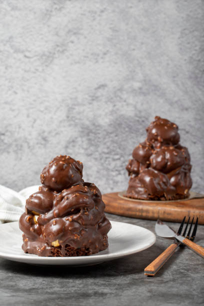 istock Chocolate cake on a dark background. Dessert with chocolate sprinkled on profiteroles grains. Bakery products 1452447441