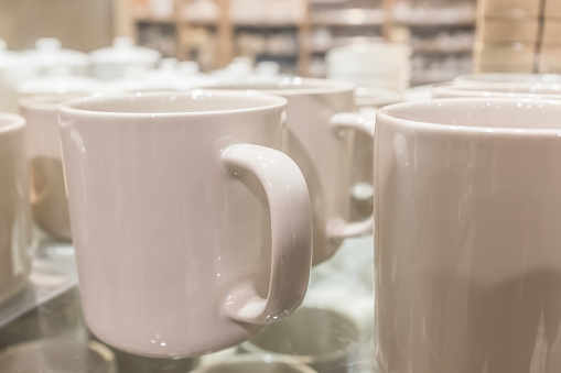 Lots of white coffee cups, mugs