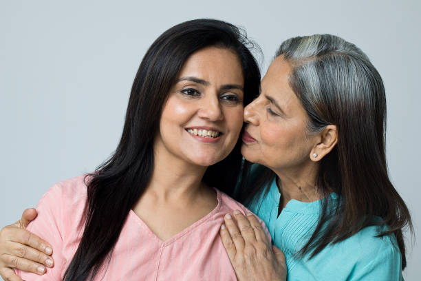istock Happy old mother kissing her daughter 1452451664