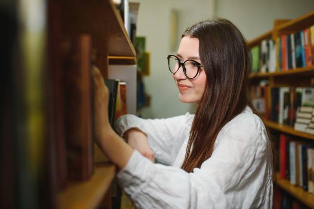 istock Portrait of a student girl studying at library 1452453998
