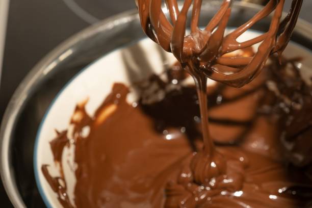 istock Closeup of melted chocolate dripping from a whisk into a bowl 1452455123