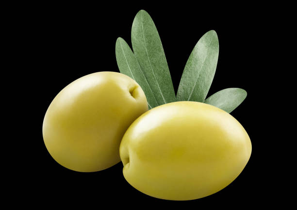 Delicious green olives with leaves, isolated on black background
