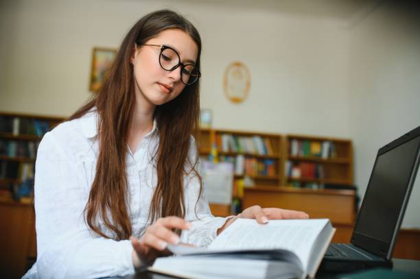 istock Portrait of a student girl studying at library 1452455418