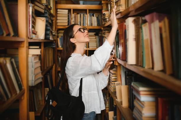 istock Beautiful girl in a library 1452455435