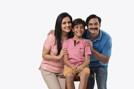 Portrait of joyful Indian family looking at camera