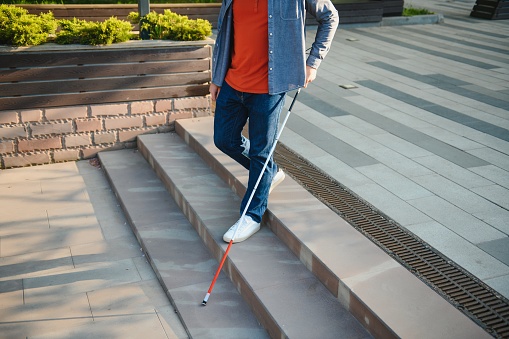 Blind man. People with disability, handicapped person and everyday life. Visually impaired man with walking stick