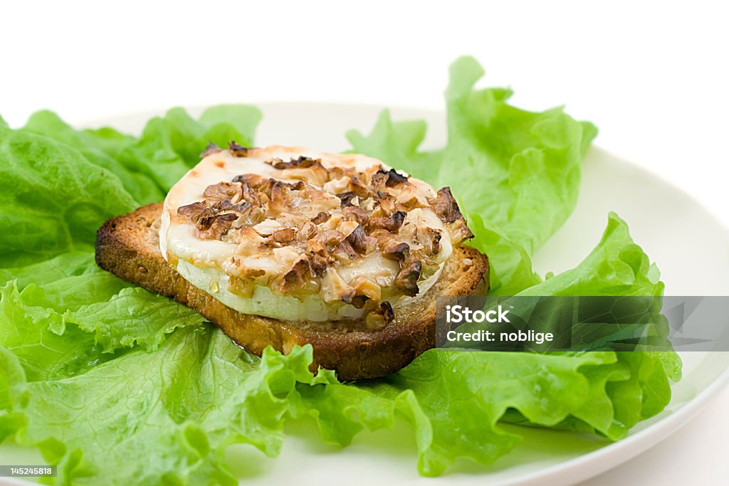 green salad with goat cheese and toast green salad with goat cheese and toast, shot on white Bread Stock Photo