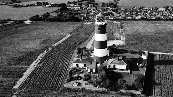An aerial grayscale of the Happisburgh Lighthouse in Hapiesburg, England, United Kingdom