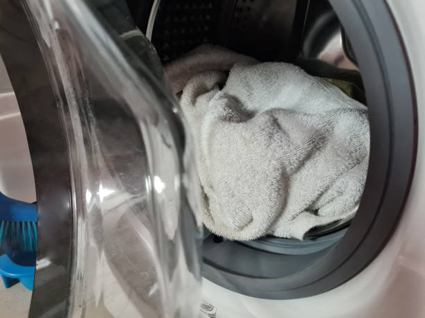 istock White linen towel in the washing machine concept 1452459070