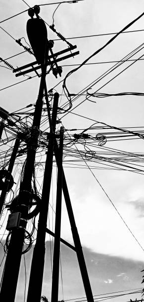 Black and white photo of electrical pole with messy wire in kijang city Indonesia Black and white photo of electrical pole with messy wire kijang stock pictures, royalty-free photos & images