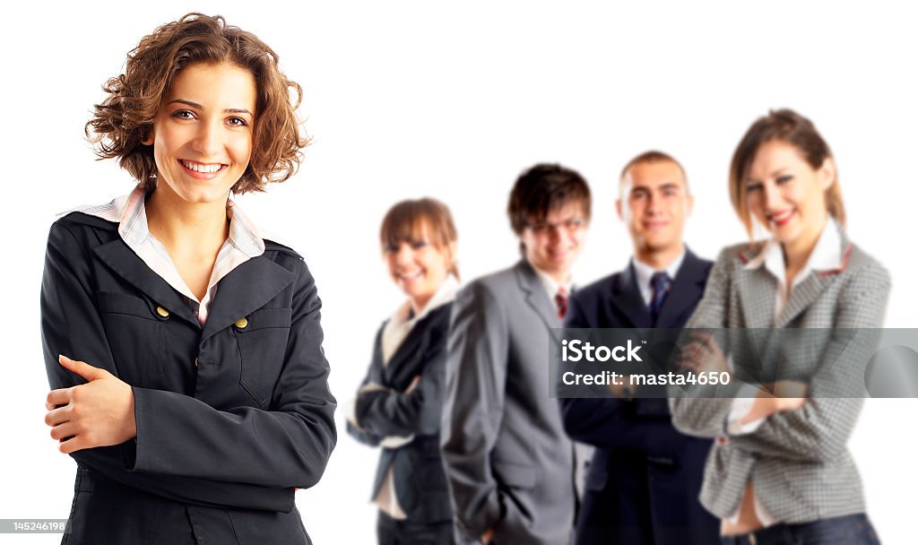 A woman focused in on with four colleagues in the background Entrepreneur with her team behind her Adult Stock Photo