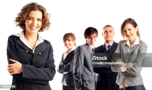 A Woman Focused In On With Four Colleagues In The Background Stock Photo - Download Image Now