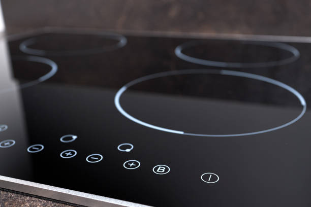 modern induction electric hob cooker with control panel buttons. electric hob detail closeup. stove top panel controls of modern kitchen. electric hob ceramic surface and touch control panel. - stove ceramic burner electricity imagens e fotografias de stock